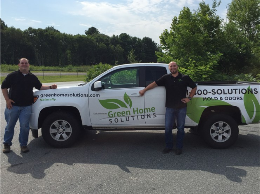 Franchise Owners posing for a picture in front of their Green Home Solutions Van. 