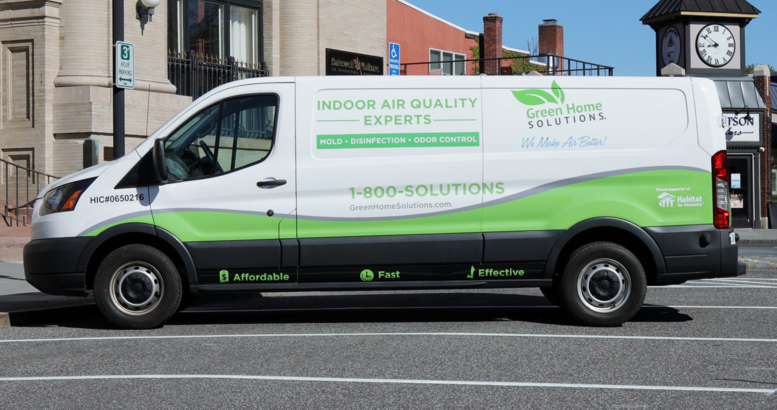 Green Home Solutions van parked on the street.